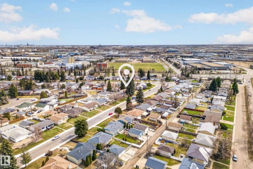 Aerial perspective of an established residential neighborhood featuring single-story homes with pitched roofs - 5304 90A Avenue, Edmonton, AB 