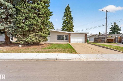 Mid-century modern exterior featuring a low-pitched roofline and horizontal siding - 5304 90A Avenue, Edmonton, AB 