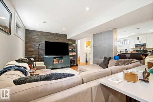 Good sized basement living room - 10649 67 Avenue, Edmonton, AB - Indoor Photo Showing Living Room With Fireplace