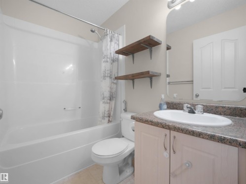 Bathroom featuring a white bathtub, toilet, and vanity with an integrated sink - 7407 Singer Landing Landing, Edmonton, AB - Indoor Photo Showing Bathroom