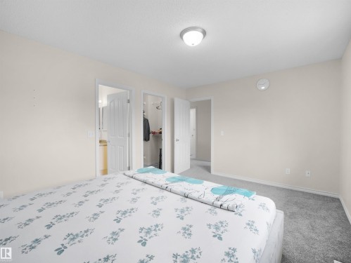 Carpeted room with neutral wall tones and white trim - 7407 Singer Landing Landing, Edmonton, AB - Indoor Photo Showing Bedroom