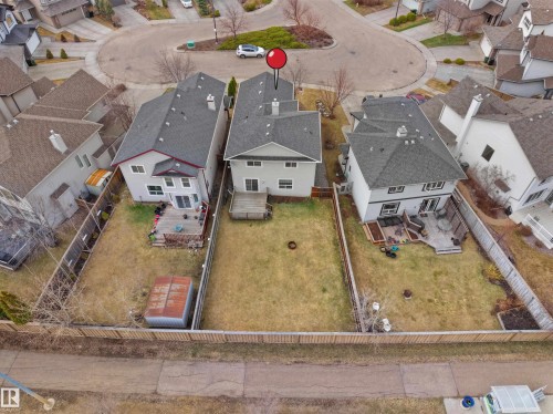 Fenced backyard with a wooden deck, sliding glass door, and a second-story window - 7407 Singer Landing Landing, Edmonton, AB - Outdoor With View