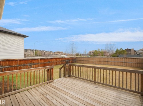 Wood deck featuring a built-in railing, steps, and a spacious backyard with a wood fence - 7407 Singer Landing Landing, Edmonton, AB - Outdoor With Deck Patio Veranda With Exterior