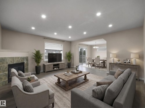 Spacious living area featuring wood-finish flooring, recessed lighting, and a tiled fireplace - 7407 Singer Landing Landing, Edmonton, AB - Indoor Photo Showing Living Room With Fireplace