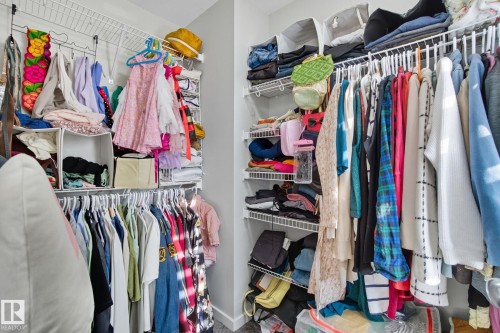 Walk-in closet featuring wire shelving and multiple hanging rods - 2039 Wonnacott Way, Edmonton, AB 