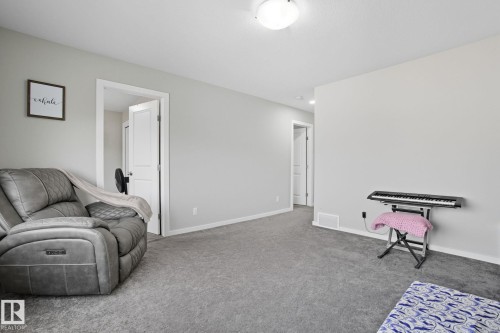 Carpeted interior space featuring light gray wall paint and white trim - 2039 Wonnacott Way, Edmonton, AB 