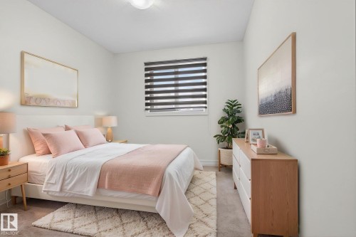 This bedroom features light-colored walls and carpeting, a window with horizontal blinds, and a light-colored wooden dresser - 1014 162 St Sw, Edmonton, AB - Indoor Photo Showing Bedroom