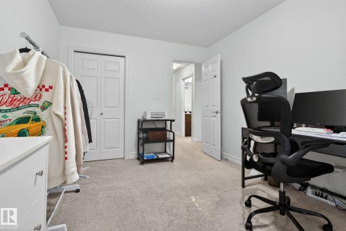 This room features light-colored carpet flooring and white walls, creating a bright and neutral space - 1014 162 St Sw, Edmonton, AB - Indoor Photo Showing Office