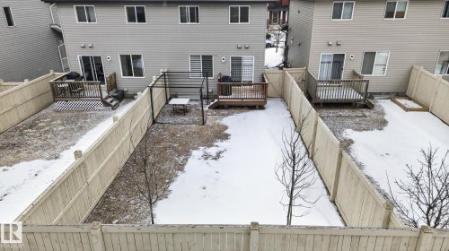The property features a private fenced yard with a wooden deck - 1014 162 St Sw, Edmonton, AB - Outdoor With Deck Patio Veranda With Exterior