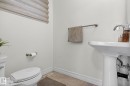Bathroom featuring a pedestal sink, toilet, and tile flooring - 1014 162 St Sw, Edmonton, AB  - Indoor Photo Showing Bathroom 
