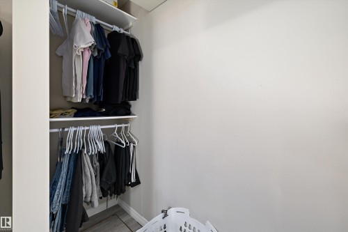 Closet with white shelving system, featuring two rods for hanging items and an overhead shelf - 4908 49 Avenue, Onoway, AB - Indoor With Storage
