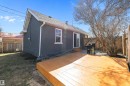 Rear exterior featuring a wooden deck, sliding glass door, and fenced perimeter - 4908 49 Avenue, Onoway, AB  - Outdoor 