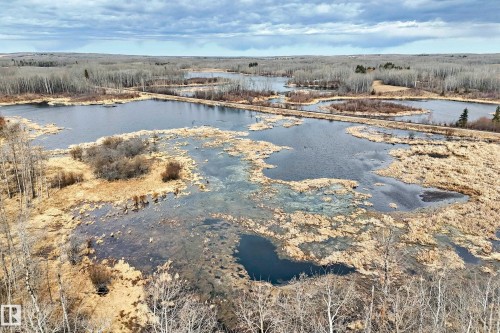 Expansive wetlands featuring multiple bodies of water surrounded by natural foliage and sparse trees - 8 54514 Rr12, Rural Lac Ste. Anne County, AB - Outdoor With Body Of Water With View