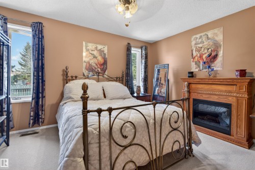 9347 175 Avenue, Edmonton, AB - Indoor Photo Showing Bedroom With Fireplace