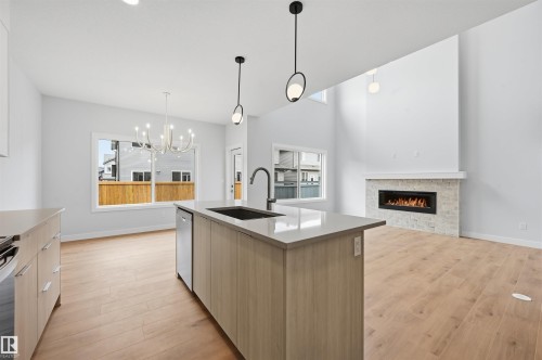 3048 Dixon Landing Landing, Edmonton, AB - Indoor Photo Showing Kitchen With Fireplace With Upgraded Kitchen