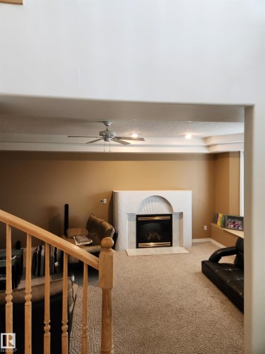 with a natural gas fireplace - 4317 53 Street, St. Paul Town, AB - Indoor With Fireplace