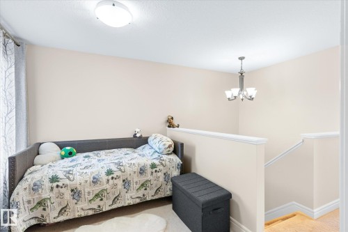 Recessed alcove featuring light neutral wall tones, white trim, and carpet flooring - 6864 Evans Wynd, Edmonton, AB - Indoor Photo Showing Bedroom