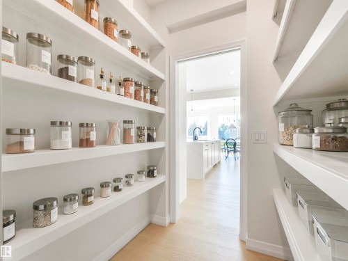 Well-appointed pantry featuring extensive white shelving and light-toned flooring - 19 Nettle Crescent, St. Albert, AB - Indoor