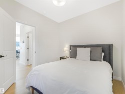 Bedroom featuring light-colored hardwood flooring and a ceiling light fixture - 