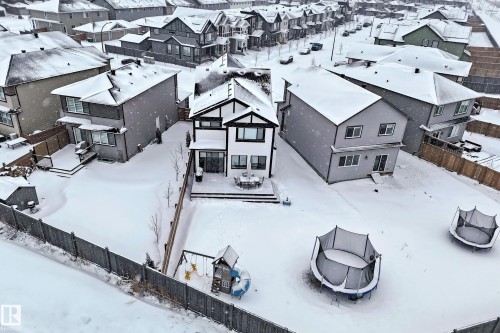 The property features a two-story exterior with a deck, a fenced yard, and a paved street - 19 Nettle Crescent, St. Albert, AB - Outdoor