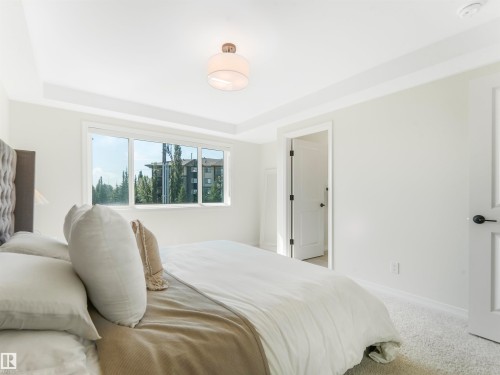 The property features a bright room with a large window, white walls, and a ceiling light fixture - 19 Nettle Crescent, St. Albert, AB - Indoor Photo Showing Bedroom