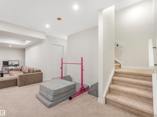 Spacious carpeted area with recessed lighting, offering versatile use - 19 Nettle Crescent, St. Albert, AB - Indoor