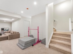 Spacious carpeted area with recessed lighting, offering versatile use - 