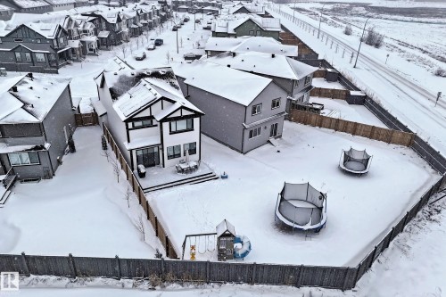 The property features a two-story exterior with dark trim detailing, a rear deck, and a fenced backyard - 19 Nettle Crescent, St. Albert, AB - Outdoor