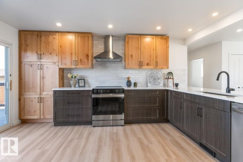 Modern kitchen featuring wood-finish flooring and recessed lighting - 4508 109A Avenue, Edmonton, AB - Indoor Photo Showing Kitchen With Upgraded Kitchen