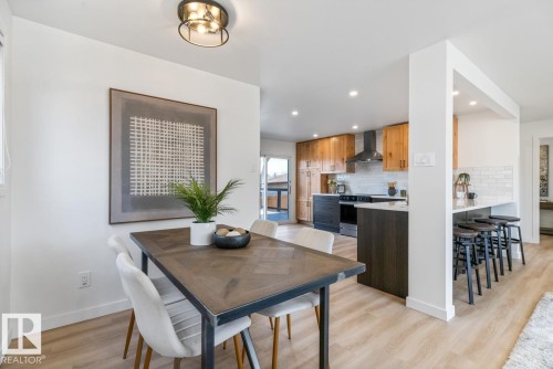 Open-concept dining area featuring light wood-finish flooring - 4508 109A Avenue, Edmonton, AB - Indoor Photo Showing Dining Room
