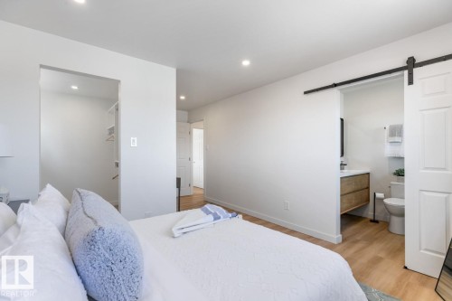 Recessed lighting illuminates a bedroom featuring light wood-finish flooring - 4508 109A Avenue, Edmonton, AB - Indoor Photo Showing Bedroom