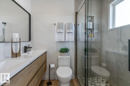Bathroom featuring a glass-enclosed shower with gray tiled walls and a hexagonal tile floor - 4508 109A Avenue, Edmonton, AB - Indoor Photo Showing Bathroom