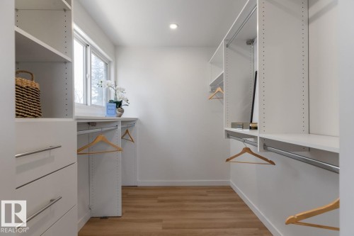 Walk-in closet featuring built-in shelving, hanging rods, and integrated drawers - 4508 109A Avenue, Edmonton, AB - Indoor