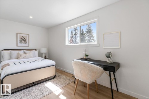 Bright room featuring wood-finish flooring, recessed lighting, and a white-trimmed window - 4508 109A Avenue, Edmonton, AB - Indoor Photo Showing Bedroom