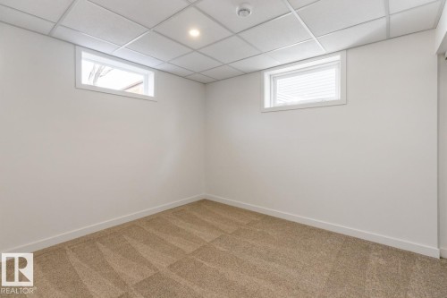 Neutral-toned carpeting covering the floor - 4508 109A Avenue, Edmonton, AB - Indoor Photo Showing Other Room