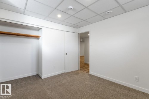 Room with light brown carpet, white walls, and a drop ceiling - 4508 109A Avenue, Edmonton, AB - Indoor Photo Showing Other Room