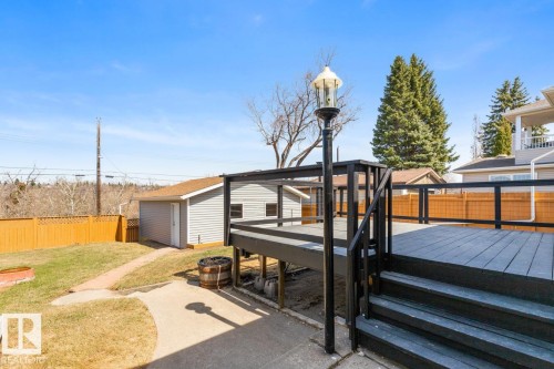 Spacious outdoor deck with dark wood-finish flooring and black railings - 4508 109A Avenue, Edmonton, AB - Outdoor