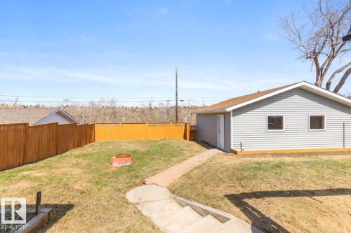 Detached garage with horizontal siding, two windows, and a shingled roof - 4508 109A Avenue, Edmonton, AB - Outdoor