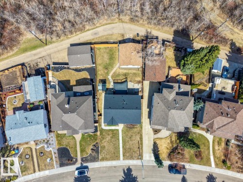 Overhead property view featuring a primary residence with a dark shingle roof, a detached garage with a light shingle roof, a paved driveway, and a landscaped front yard with a walkway - 4508 109A Avenue, Edmonton, AB -  With View