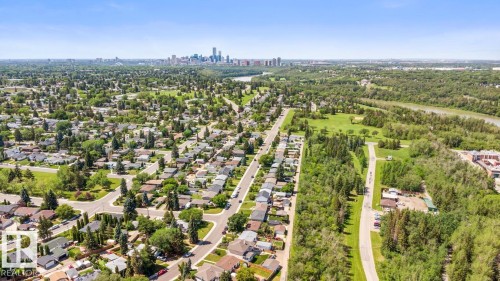 Aerial capture showcasing a residential neighborhood with a distant cityscape - 4508 109A Avenue, Edmonton, AB - Outdoor With View