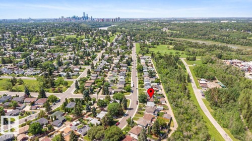 Aerial perspective showcasing a residential area with varied housing styles, mature trees, and paved streets - 4508 109A Avenue, Edmonton, AB - Outdoor With View