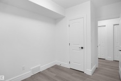 Interior space featuring light wood-finish flooring, white walls, and bright white trim - 