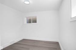 Room featuring white walls and wood-finish flooring - 
