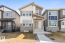 Contemporary two-story exterior featuring a covered front entry and integrated stone accents - 6625 46 Avenue, Beaumont, AB  - Outdoor With Facade 