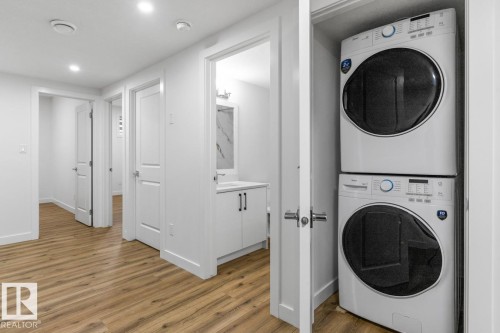 Dedicated laundry closet featuring a stacked washer and dryer - 6625 46 Avenue, Beaumont, AB - Indoor Photo Showing Laundry Room