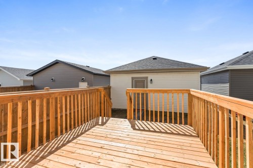 Expansive wooden deck featuring natural wood planks and sturdy railings - 6625 46 Avenue, Beaumont, AB - Outdoor With Deck Patio Veranda With Exterior