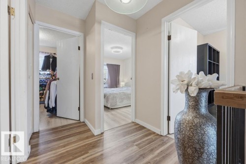 Hallway with wood-finish flooring and light beige wall paint - 7422 188 Street, Edmonton, AB - Indoor Photo Showing Other Room