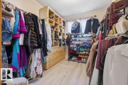Custom closet system featuring wood-finish cabinetry and drawers - 