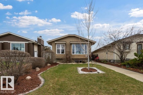 Single-story property with horizontal siding, multiple windows, and a paved walkway - 7422 188 Street, Edmonton, AB - Outdoor