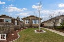 Single-story property with horizontal siding, multiple windows, and a paved walkway - 7422 188 Street, Edmonton, AB  - Outdoor 